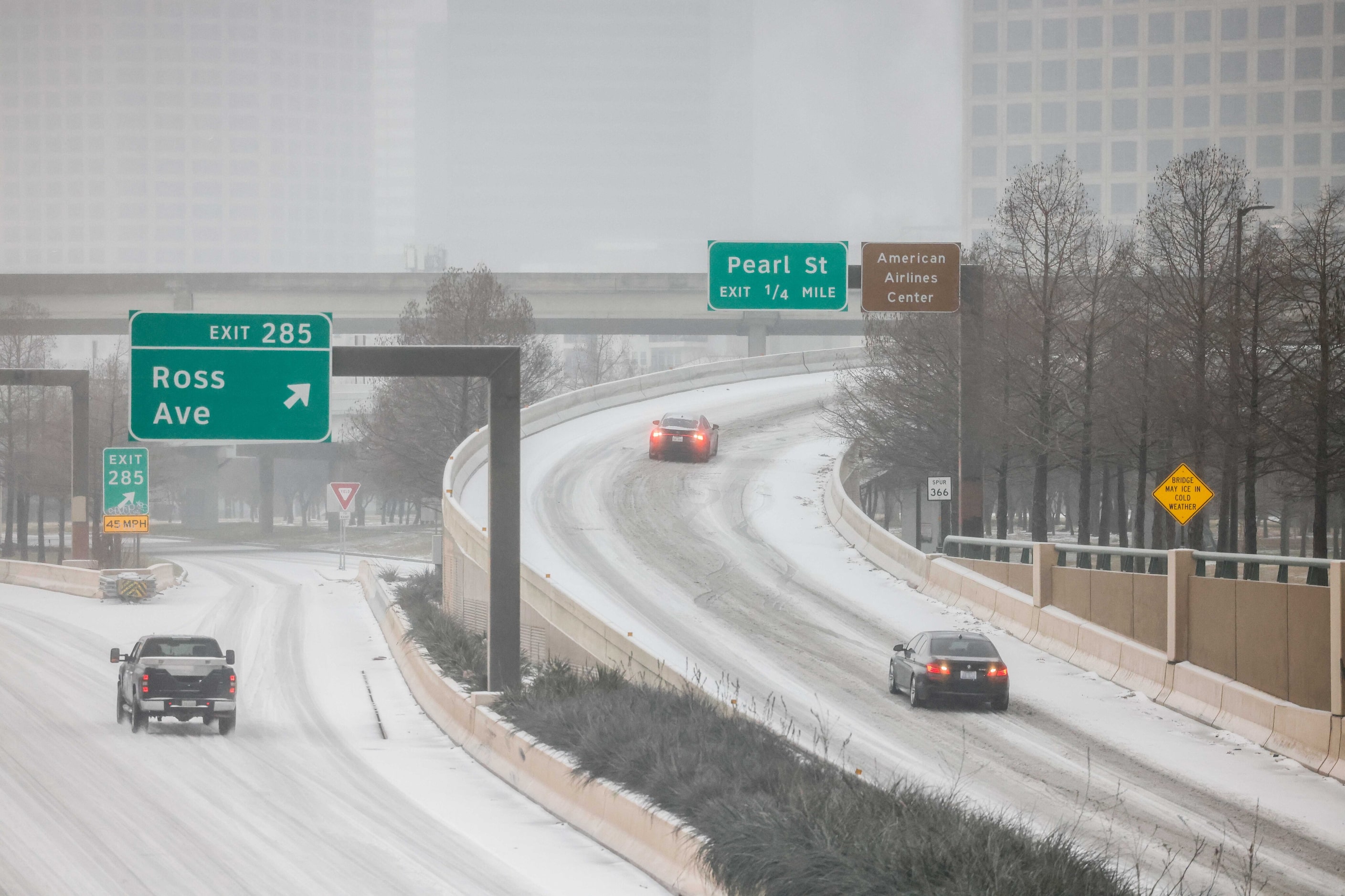 Road conditions for some motorists begin to become difficult as sleet falls over the Dallas...