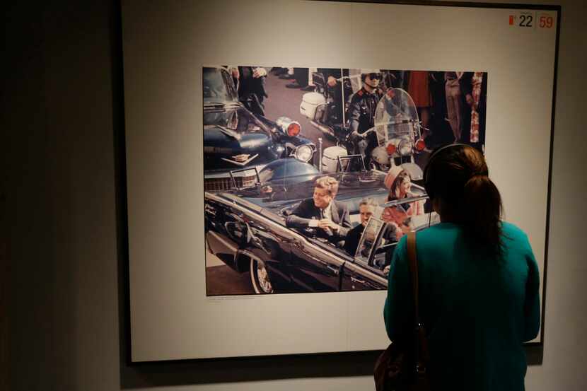  A patron looks at a photo of President John F. Kennedy in a motorcade in Dallas before his...