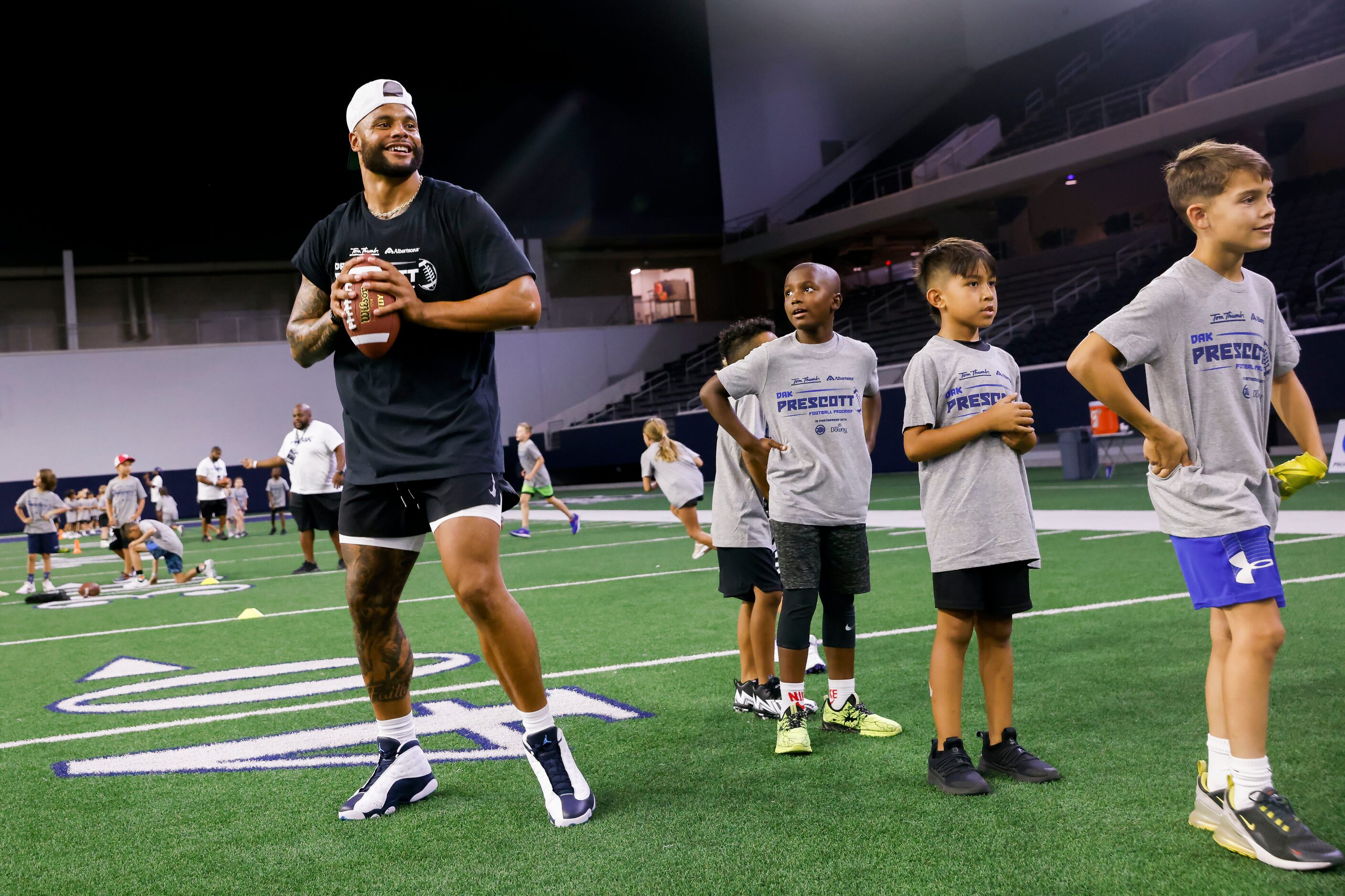 Cowboys quarterback Dak Prescott gets ready to throw the ball while running drills during...