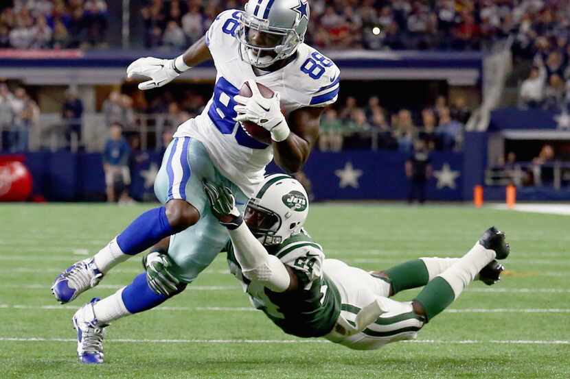 Dez Bryant #88 of the Dallas Cowboys carries the ball and scores a touchdown against ...