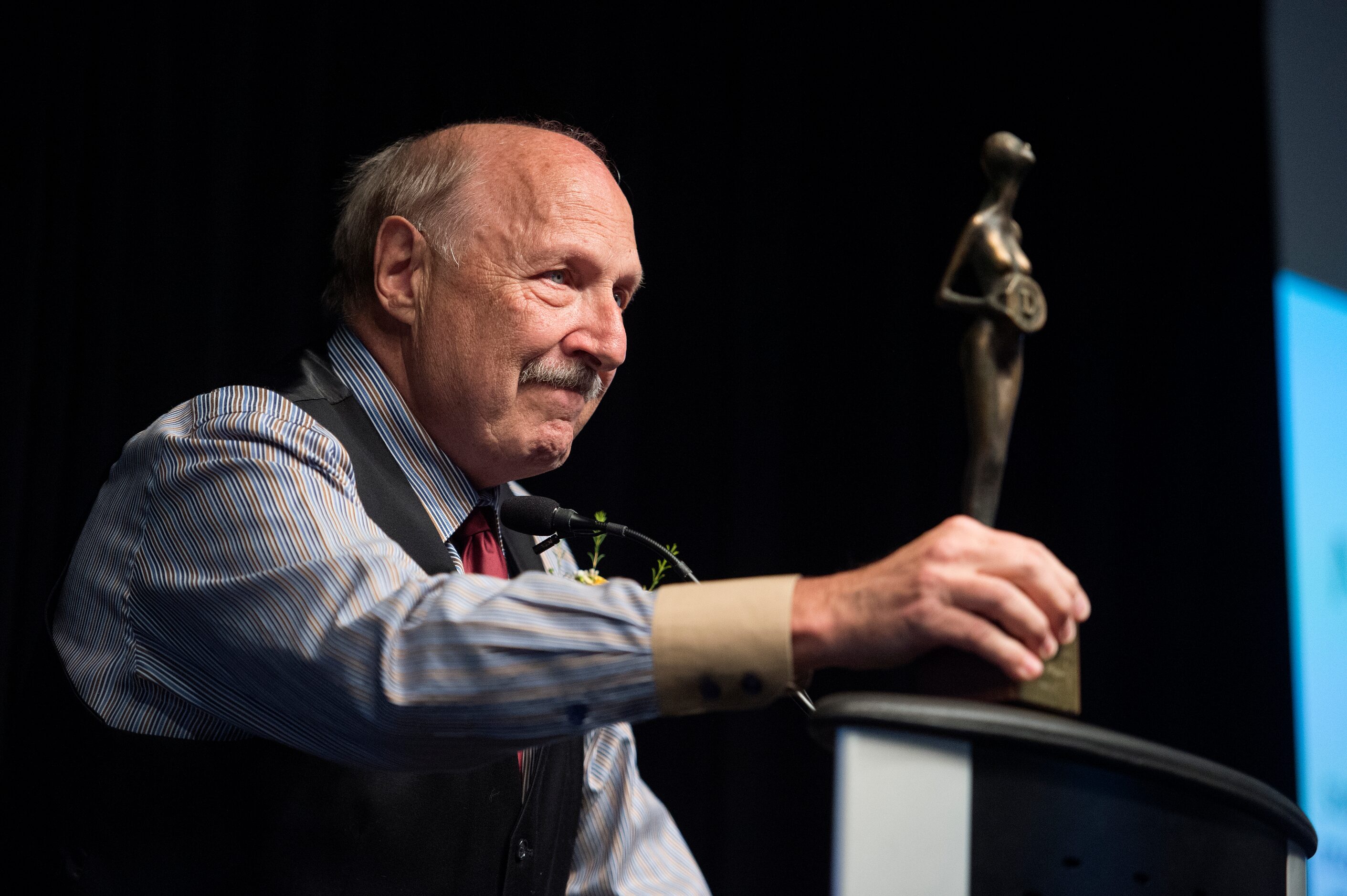 Dallas sports talk radio host Norm Hitzges displays an award he was given by the Press Club...