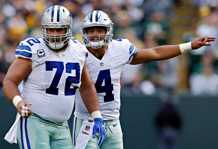 Dallas Cowboys quarterback Dak Prescott (4) yells at center Travis Frederick during Dallas'...