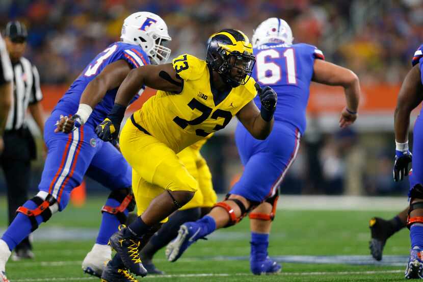 FILE - Michigan defensive tackle Maurice Hurst (73) rushes at the line of scrimmage during a...