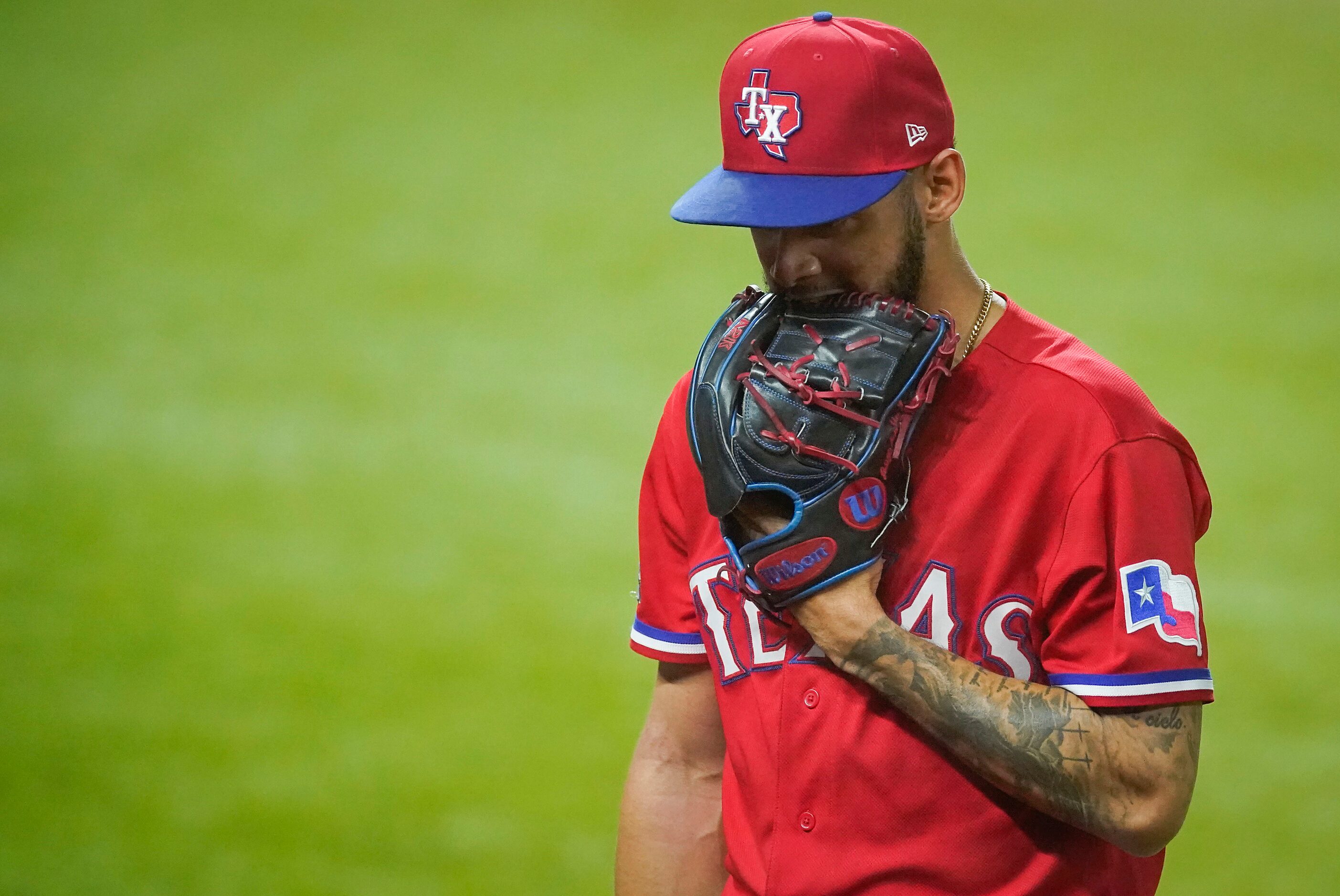 Texas Rangers pitcher Jonathan Hernandez heads for the dugout after giving up one run to the...