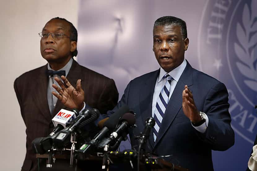 Dallas County Commissioner John Wiley Price (left) listens as Department of Health and Human...