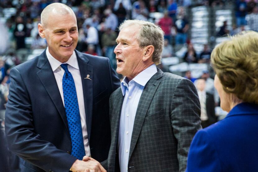 Dallas Mavericks head coach Rick Carlisle greets former President George W. Bush and former...