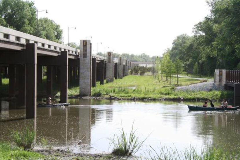 
Canoers cross below Abrams Road and the White Rock Creek Trail on April 27. The trail will...