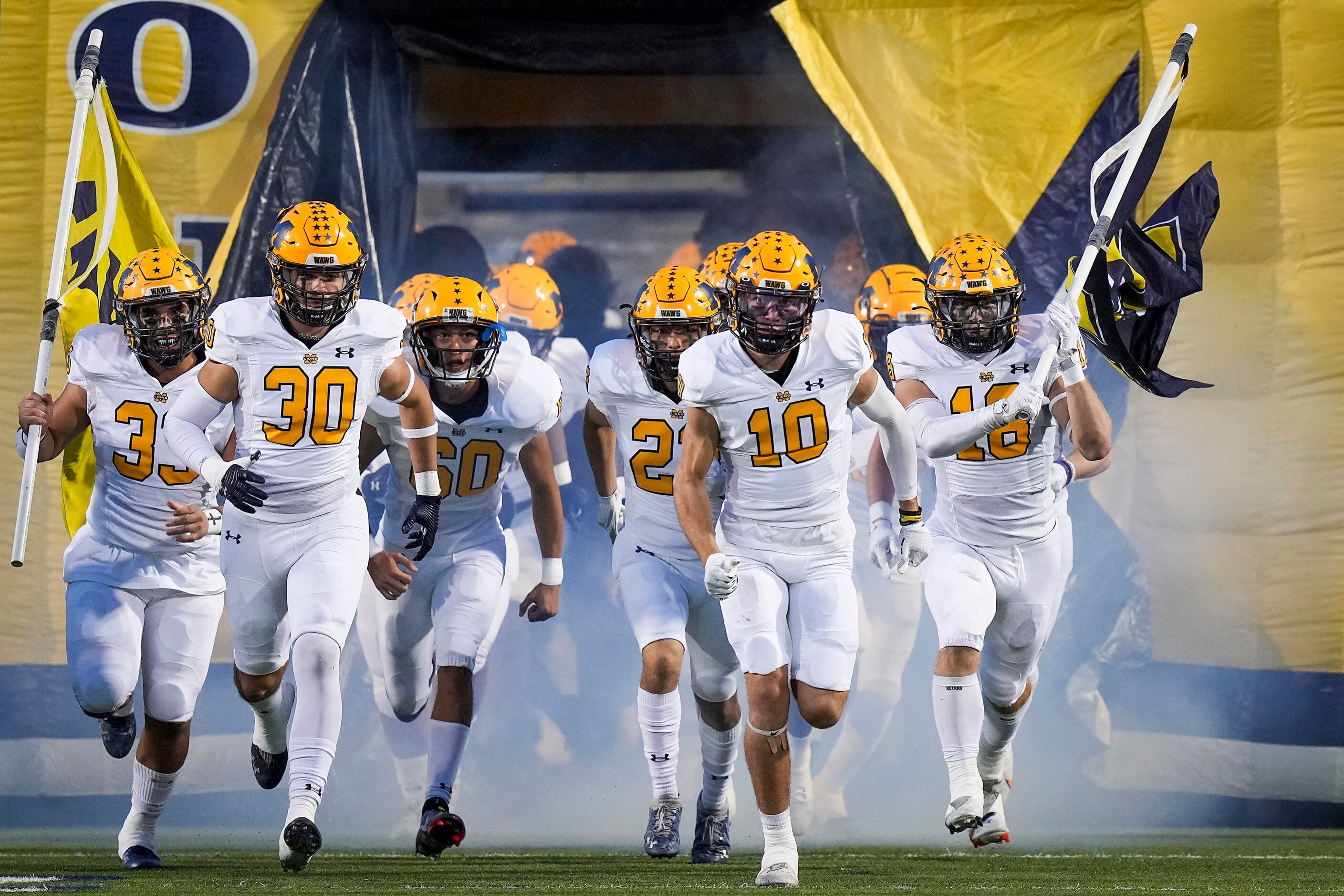 McKinney players take the field before the first half of a District 5-6A high school...