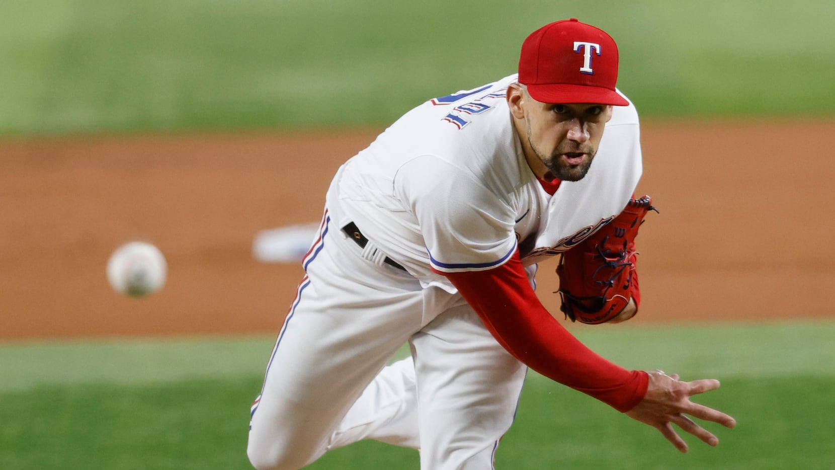 Texas Rangers pitcher Nathan Eovaldi delivers during the first inning of a baseball game...