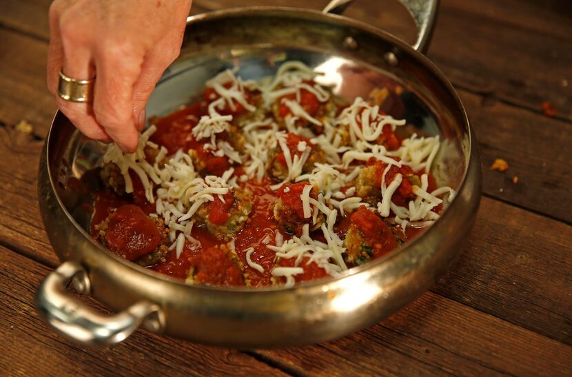 Ellise Pierce puts mozzarella cheese on Eggplant No-Meatballs.