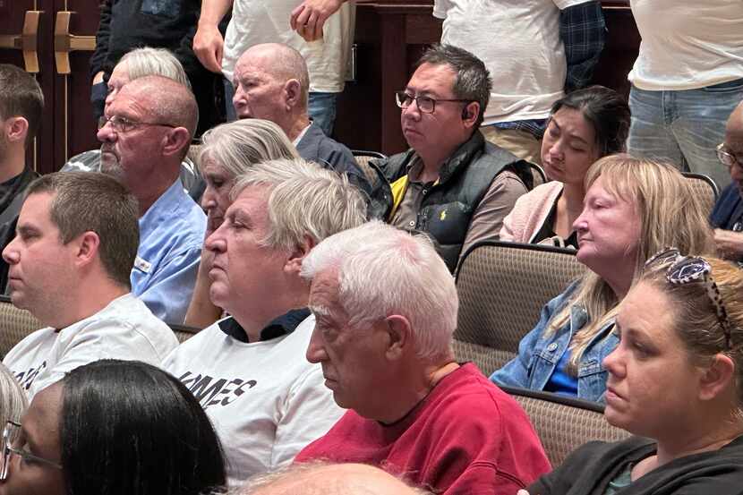 Audience members wear shirts showing opposition of short-term rental properties during a...