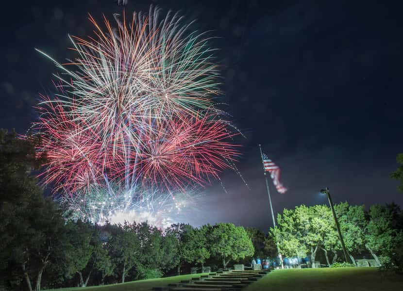 Fireworks explode over Flag Pole Hill after the Dallas Symphony Orchestra's Memorial Day...