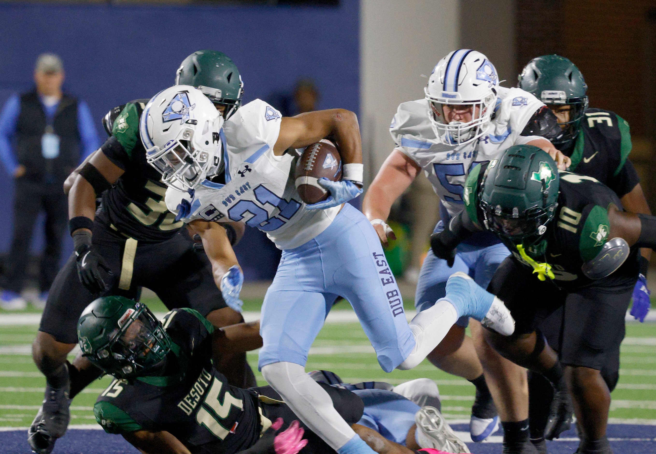 Wylie East's Michael Henderson III (21) carries the ball as Wylie East's James Reed (53)...