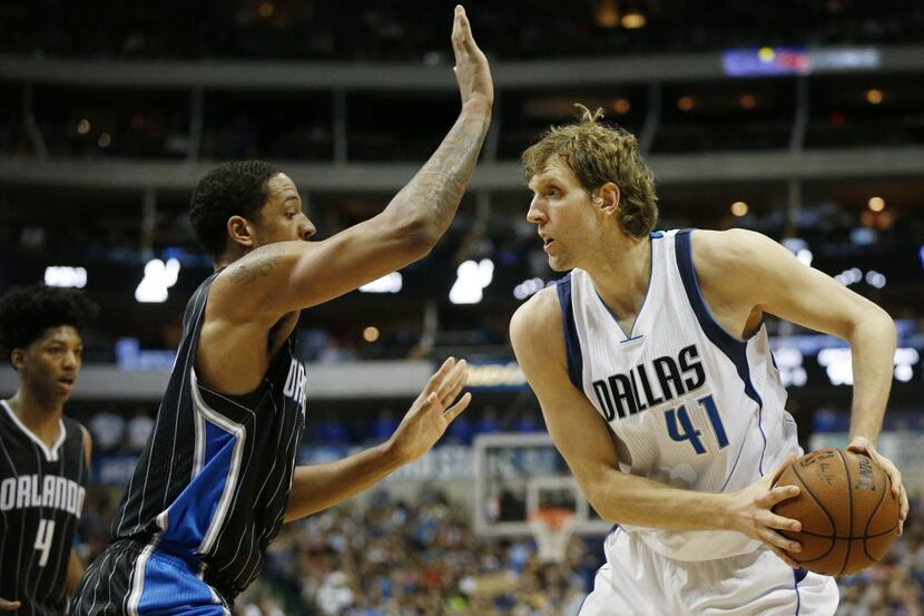Dallas Mavericks forward Dirk Nowitzki attempts to move the ball around Orlando Magic...