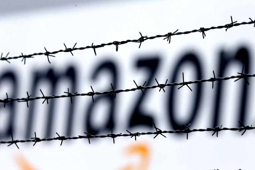 FILE - In this Feb. 19, 2013 file photo, the internet trader Amazon logo is seen behind...