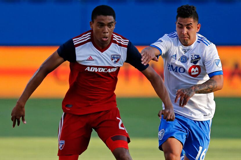 FC Dallas defender Reggie Cannon (2) is defended by Montreal Impact forward Jeisson Vargas...