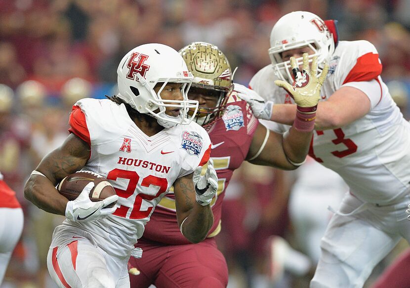 Ryan Jackson #22 of the Houston Cougars runs against Fredrick Jones #55 of the Florida State...