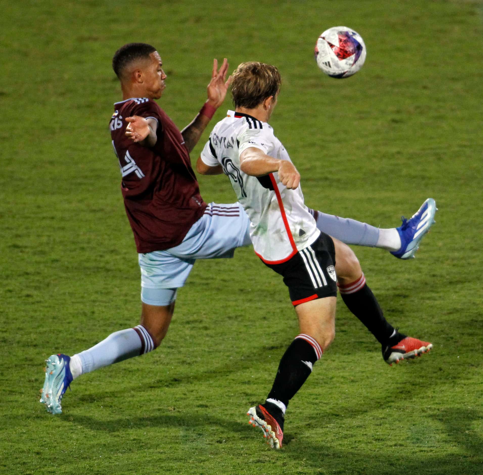 FC Dallas midfielder Alan Pomykal (19), right, challenges Colorado attacker Calvin Harris...