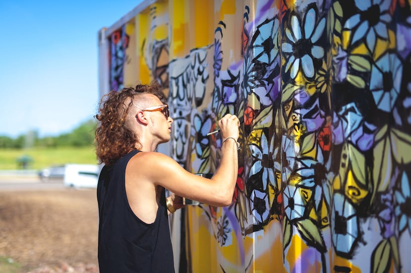 Brinston paints his mural "Bonton Blessing" at Bonton Farms in South Dallas. The mural is...