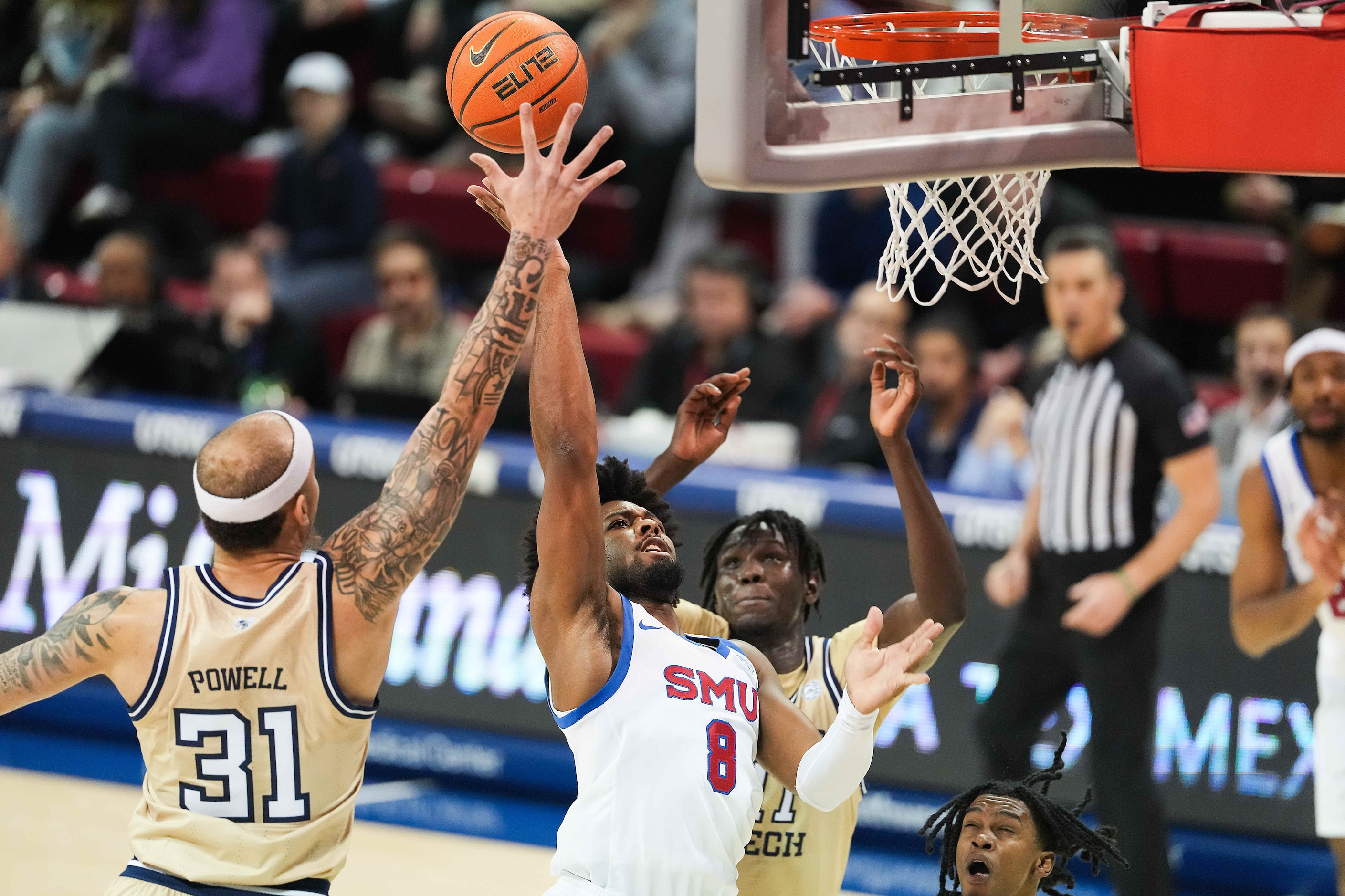 SMU guard Kario Oquendo (8) shoots past Georgia Tech forward Duncan Powell (31) during the...