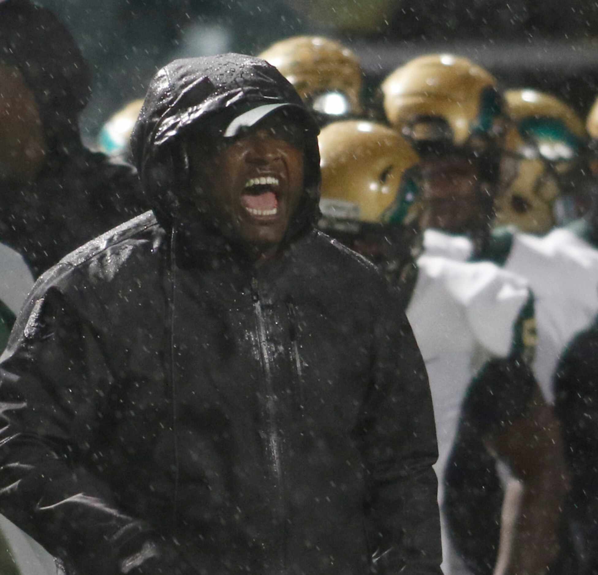 DeSoto head coach Claude Mathis sends a message from the team bench area during first half...