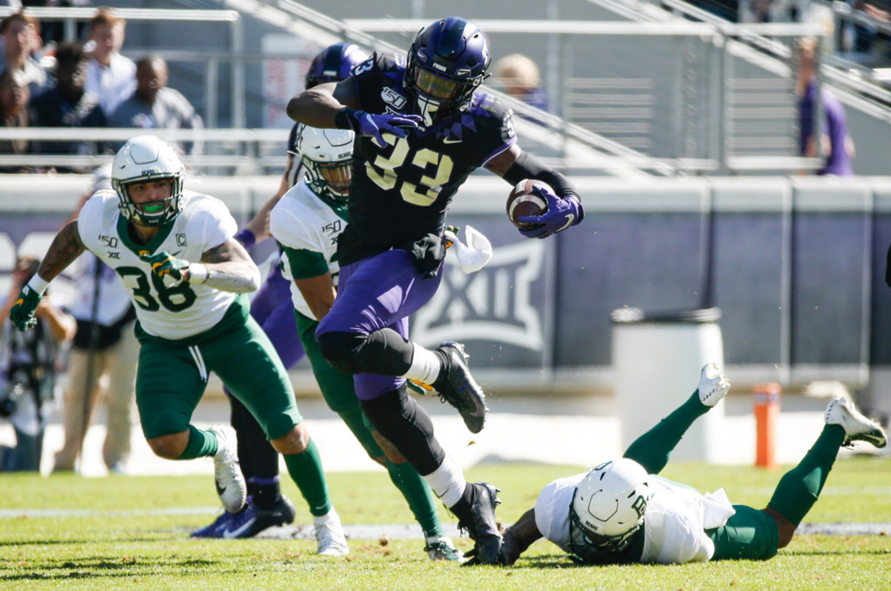 TCU Horned Frogs running back Sewo Olonilua (33) runs a lane past Baylor Bears linebacker...