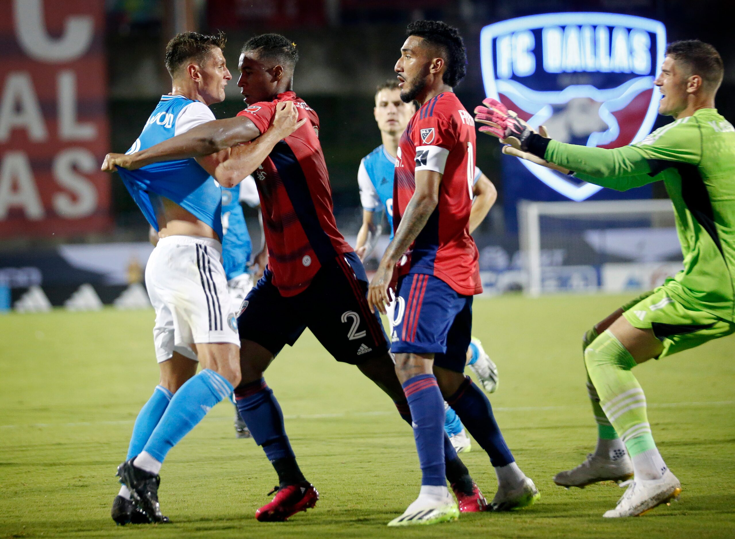 Charlotte FC defender Jan Sobociński (2) is held back by FC Dallas defender Geovane Jesus...