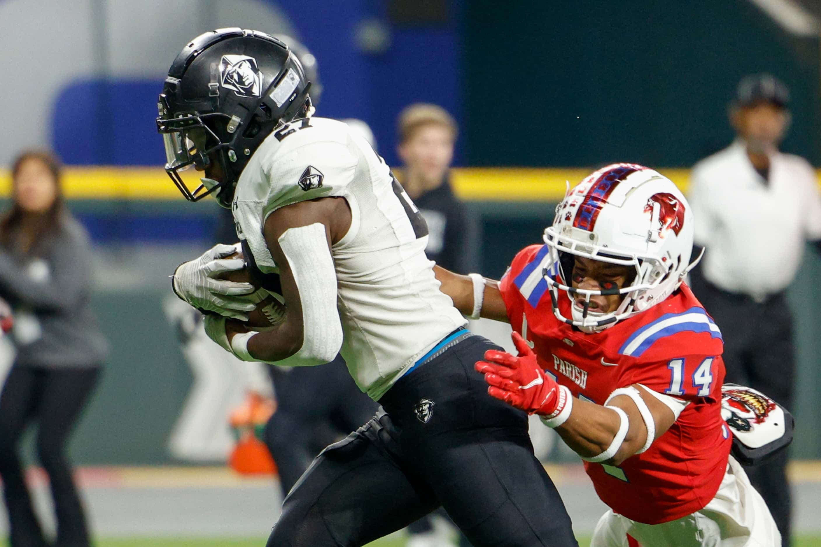 Bishop Lynch’s Godswill Gladolor (27) runs through a tackle from Parish Episcopal defensive...