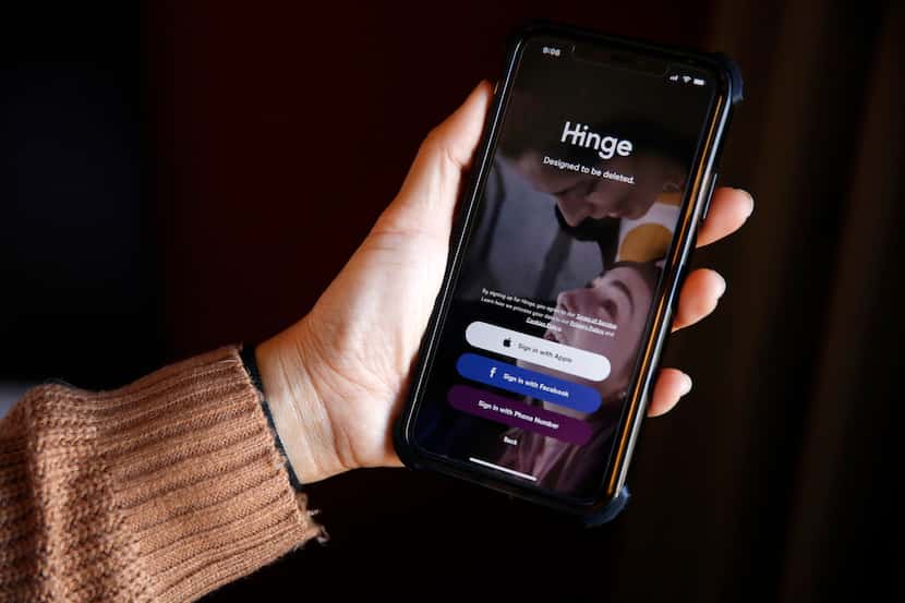 A Carrollton woman holds out her phone showing Hinge, a dating app.