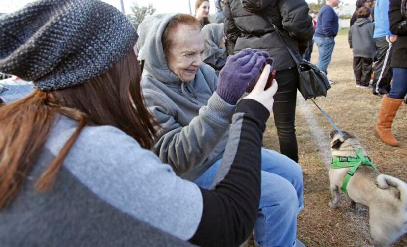 
Alexa Meyers (left) showed her grandmother, Estelle Shwiff, some photos of the day’s...