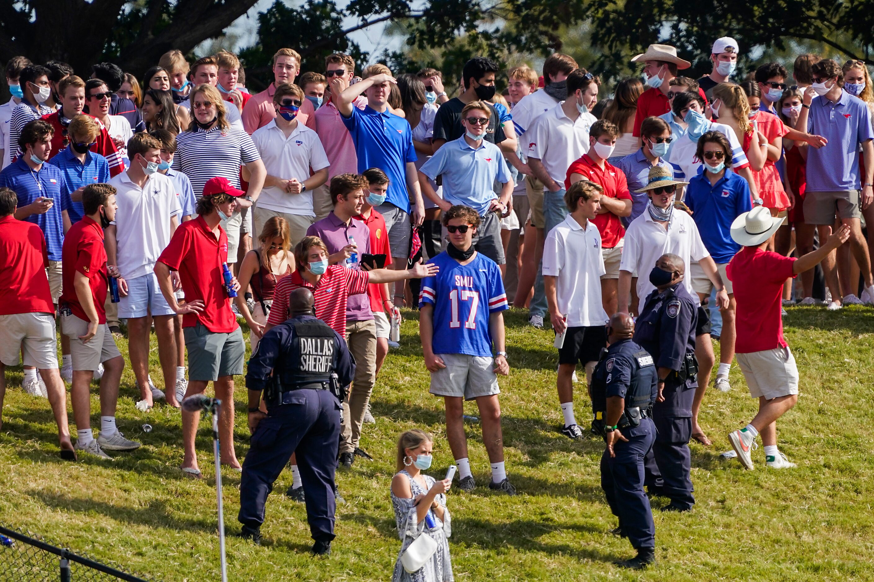 SMU students argue with law enforcement as they clear fans from the hill in the south end...