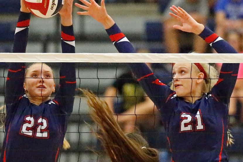 Allen High School right side Emily Janek (22) gets a block next to team mate, middle Avery...