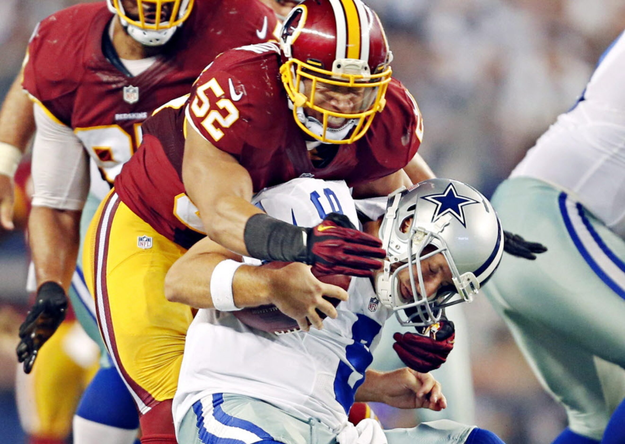 Dallas Cowboys quarterback Tony Romo is sacked and injured by Washington Redskins inside...