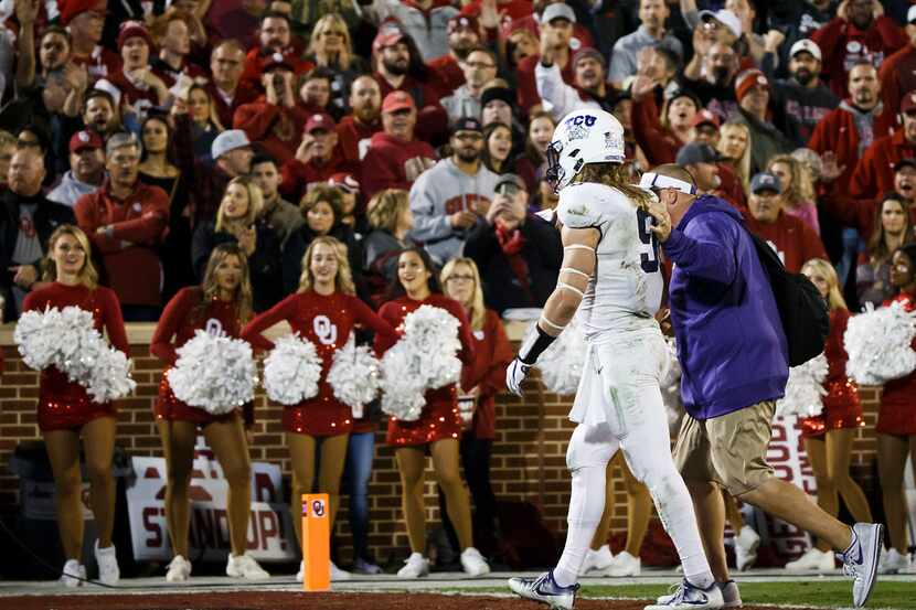 TCU defensive end Mat Boesen (9) is escorted off the field after being ejected during the...