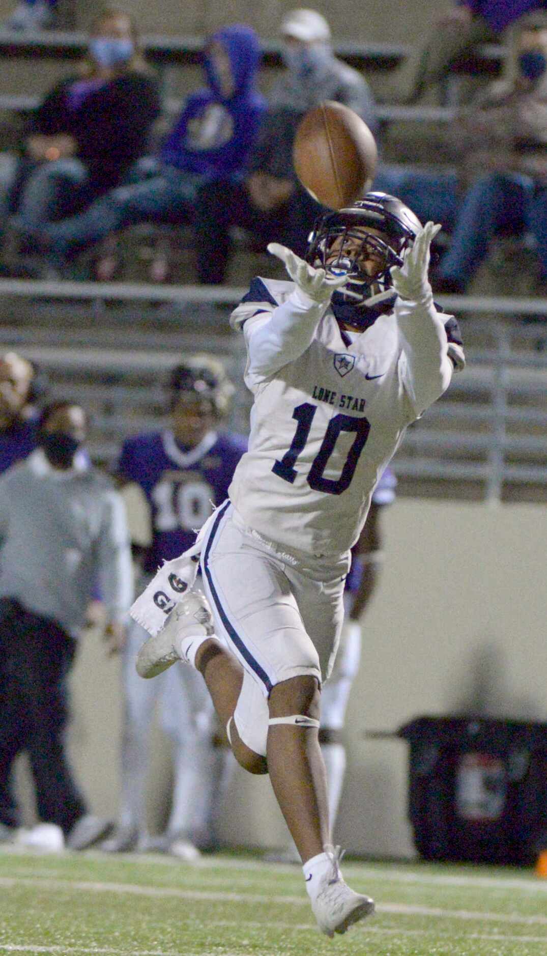 Lone Star’s Gerald Harris makes a catch in the second quarter of a high school football game...