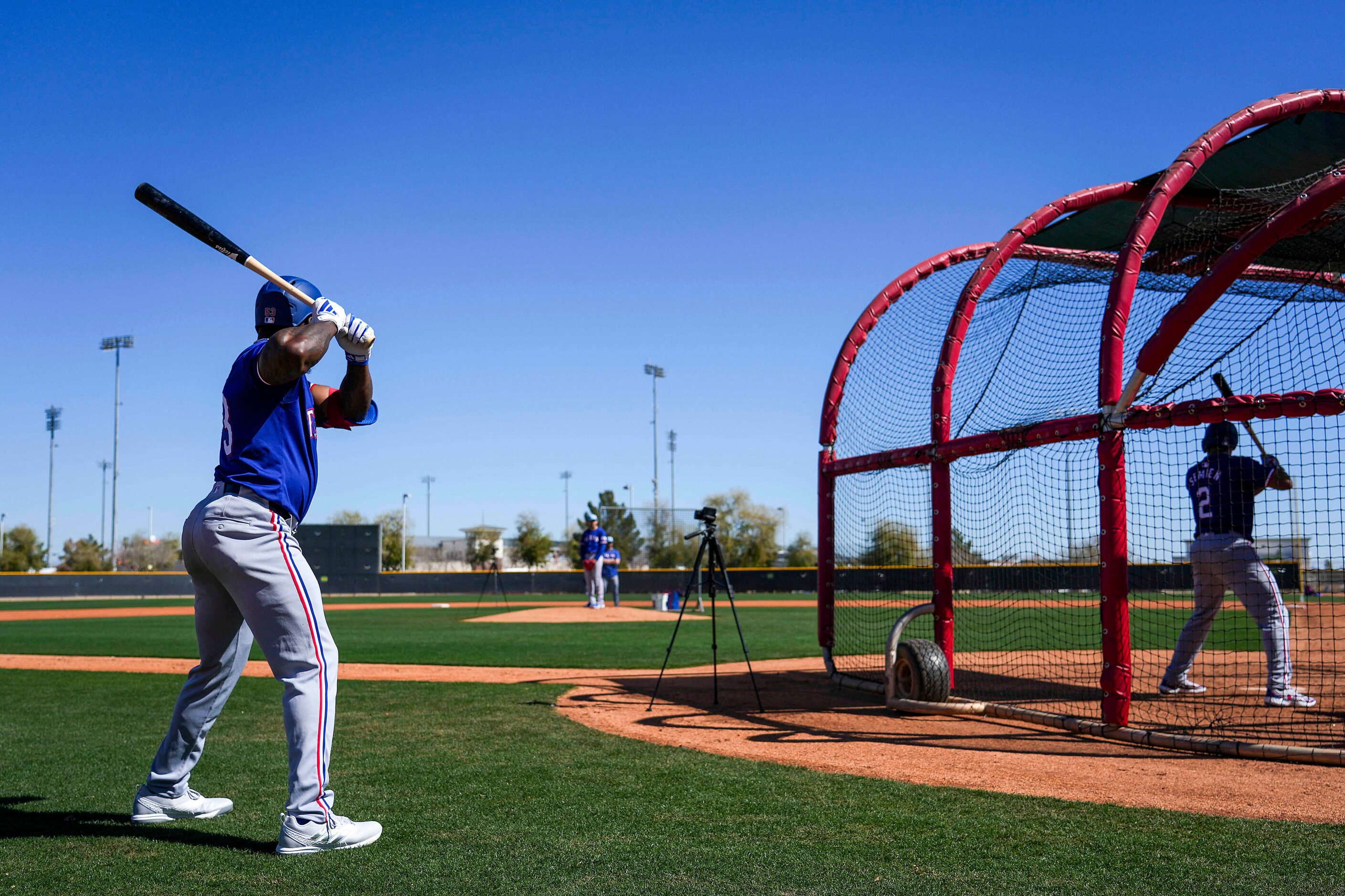 Texas Rangers outfielder Adolis García waits his turn to hit as infielder Marcus Semien (2)...