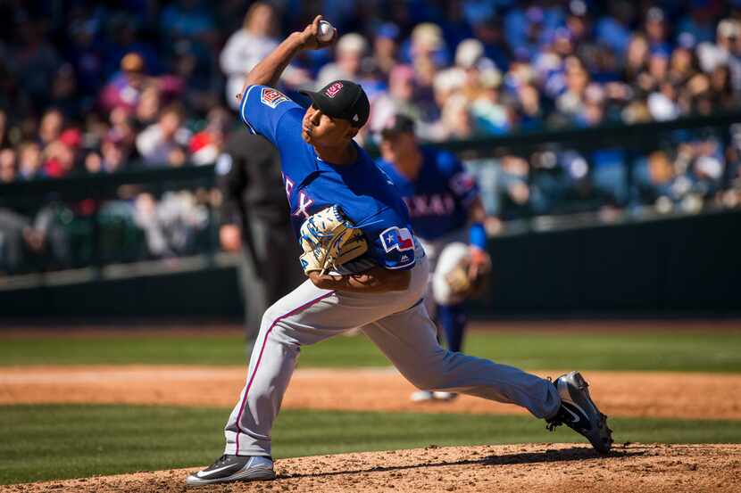 Texas Rangers pitcher Jose Leclerc pitches during the third inning of a spring training...