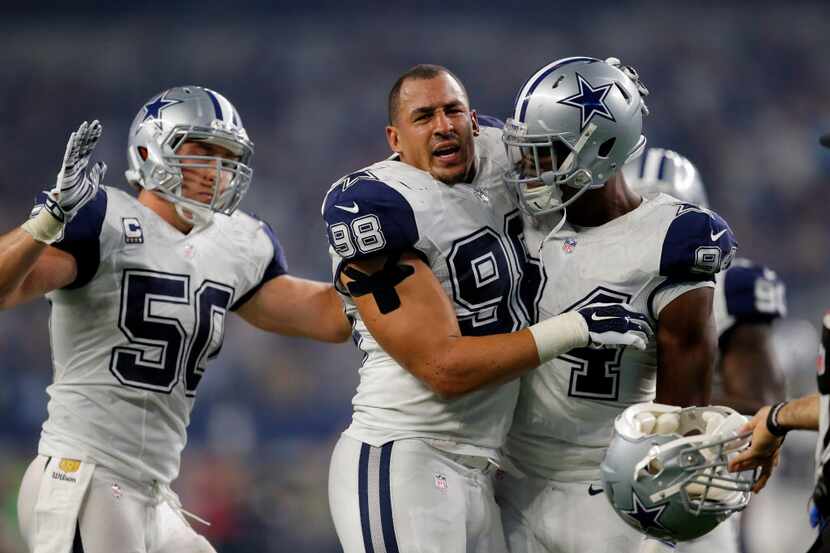 Dallas Cowboys' Sean Lee (50) and Randy Gregory celebrate with Tyrone Crawford (98) after...