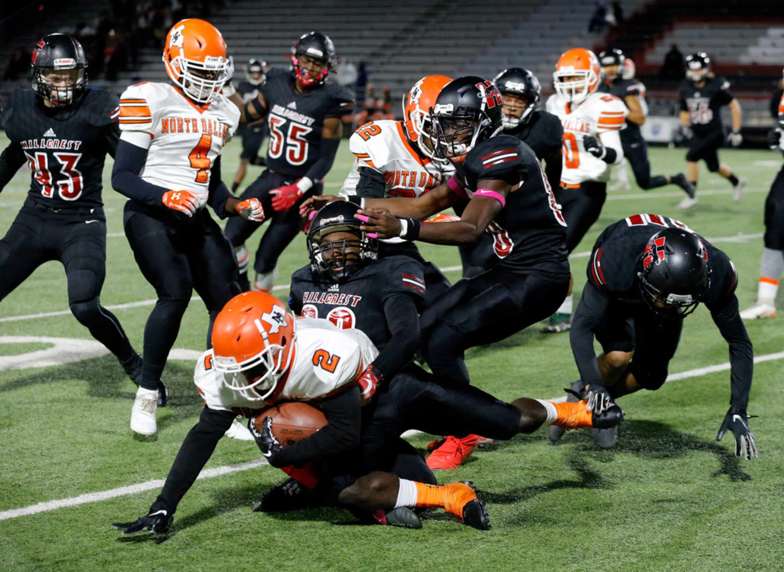 North Dallas RB Tray Shaw (2) is swarmed by the Hillcrest High defense, during the first...