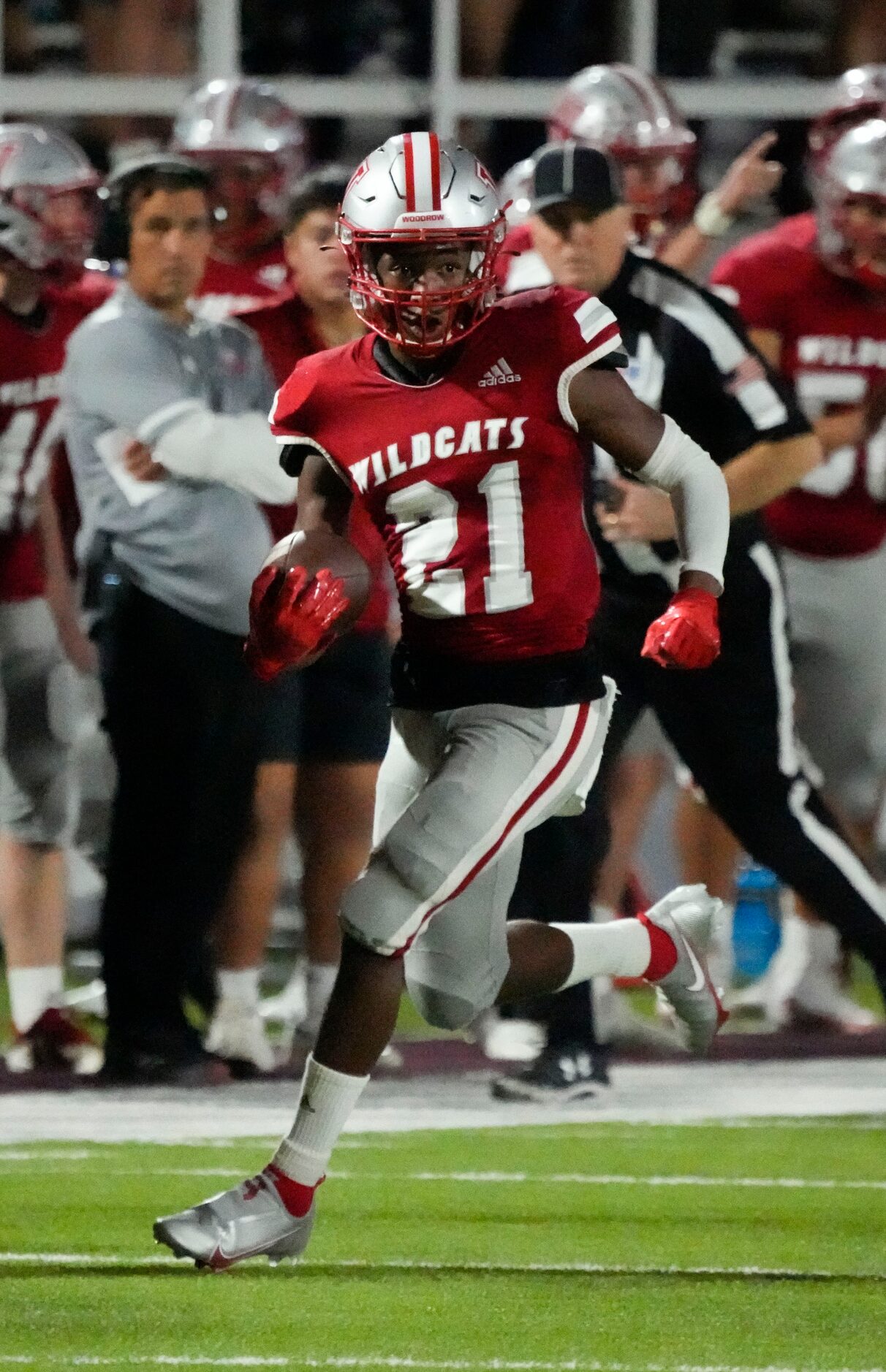 Woodrow Wilson junior Boris Taylor (21) looks for room against the W.T. White defense on a...