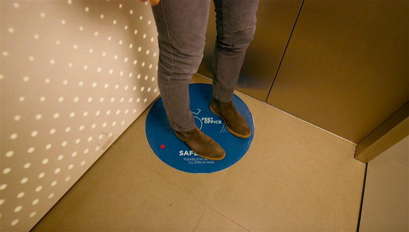 Landing pads in the elevator keep workers separated on the ride up to the office.