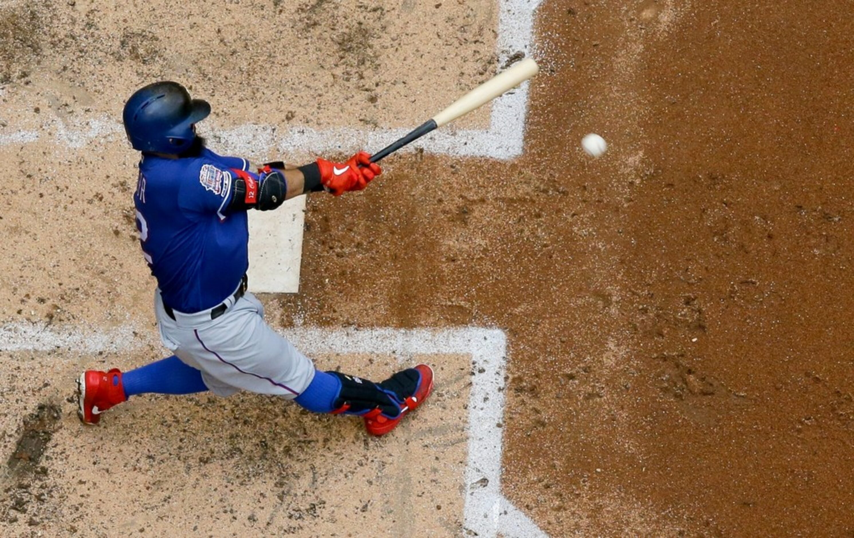 Texas Rangers' Rougned Odor hits a double during the seventh inning of a baseball game...