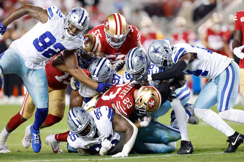 The Dallas Cowboys defense has trouble stopping San Francisco 49ers running back Christian...