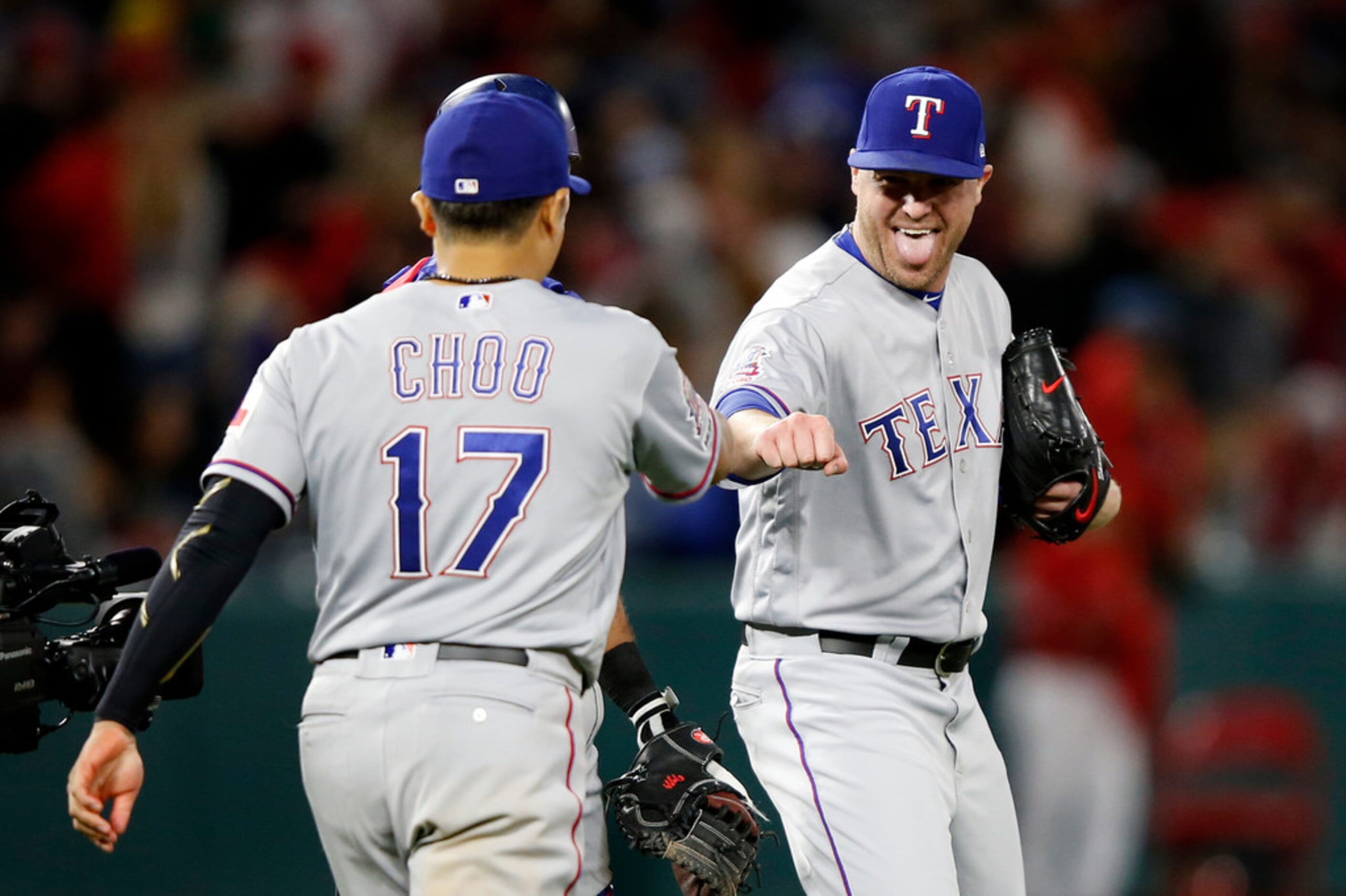 ANAHEIM, CALIFORNIA - MAY 24:  Shin-Soo Choo #17 congratulates Shawn Kelley #27 of the Texas...