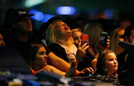 Audience members sing along with Koe Wetzel during the Heart o' Texas Fair in Waco.