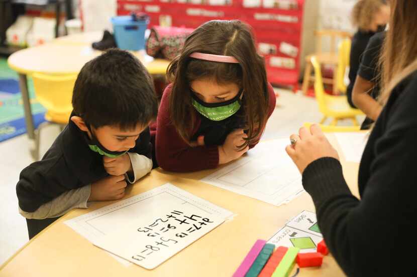 PreK students Mykah Steorts and Jolie Murrugarra (right) works on an addition problem at a...