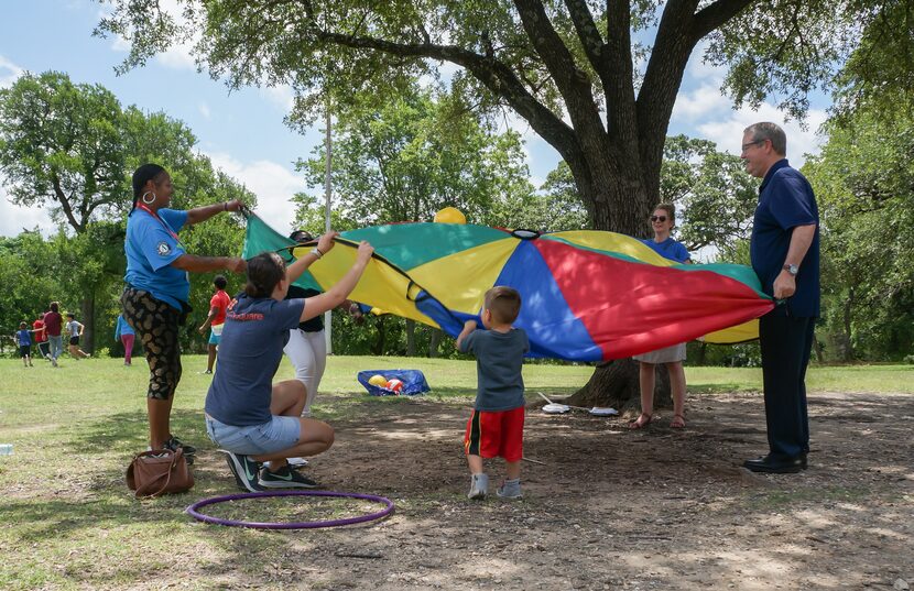 CitySquare CEO Larry James (right) helps set up a picnic with staff and neighbors.