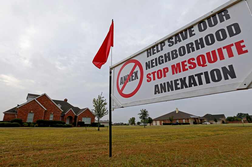 A sign is seen on the front yard at 10474 Walnut Lane, a Forney address. Many Kaufman County...
