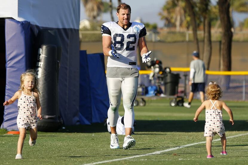 Dallas Cowboys tight end Jason Witten calls to his 1 yr-old daughter Hadley as his 3 yr-old...