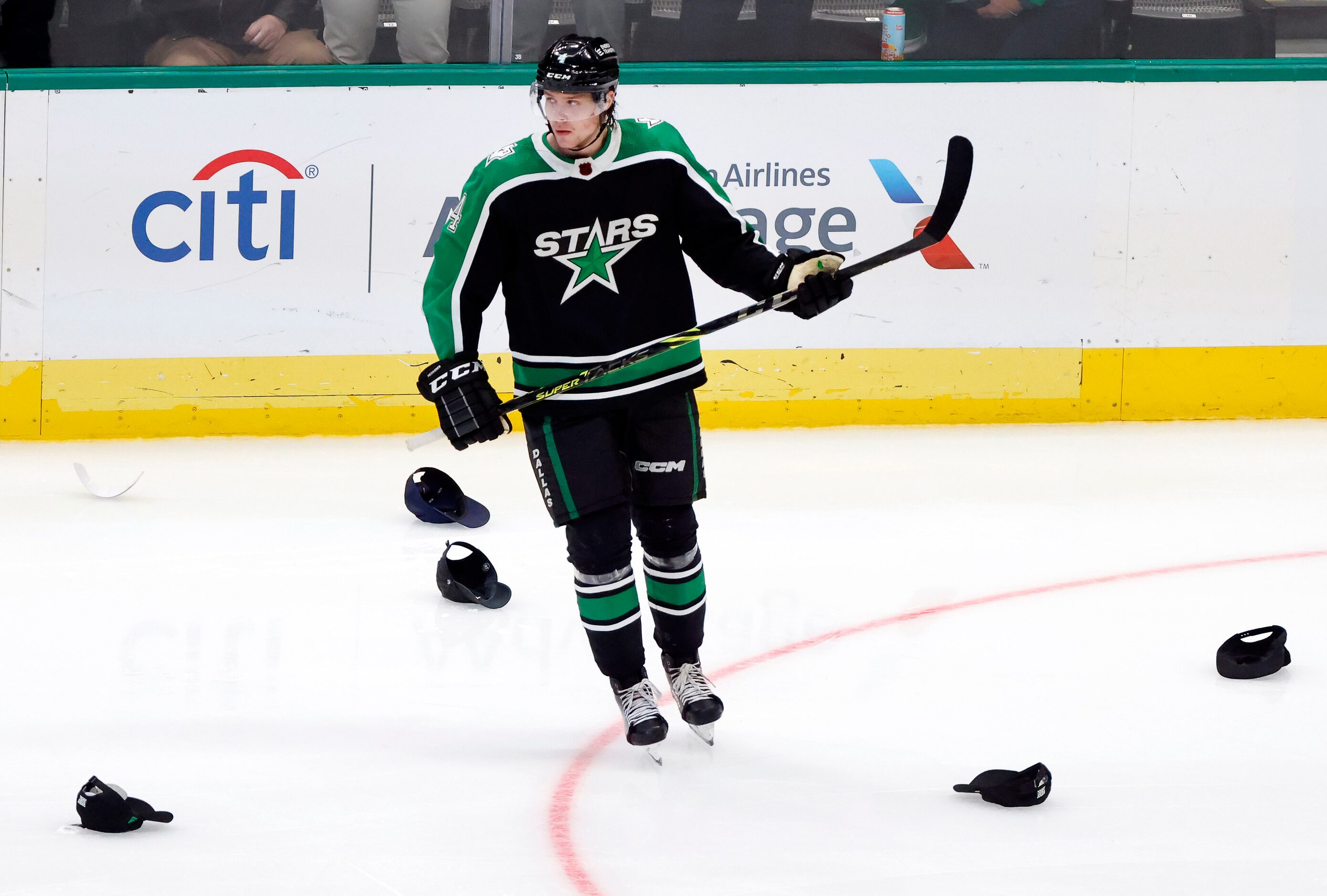 Dallas Stars defenseman Miro Heiskanen (4) skates among the hats after he made an assist for...